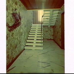 Natural Stone marble floor and staircase in the foyer o...