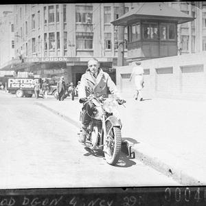 Salesman demonstrating a Francis-Barnett motorcycle