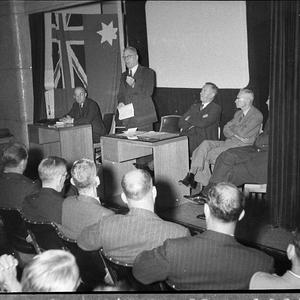 Mr Morrow speaking to a crowd of men in the demonstrati...