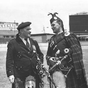 Two Highland pipers talking together at the Highland So...