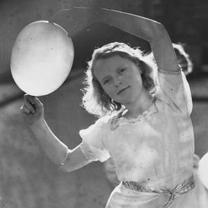 A girl competitor dancing with a balloon