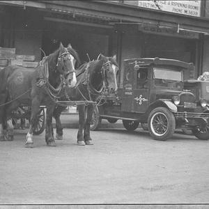 Loading dock with delivery trucks and horsedrawn drays