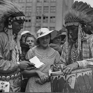 Woman with Native Americans in feather head-dresses