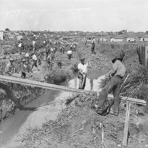 Depression relief workers digging a stormwater canal