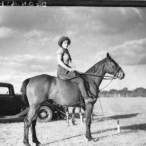 A young woman umpire on her pony