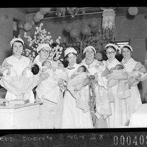 Six nurses holding babies