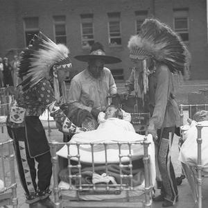 Three American Indians from the Stampede visit sick chi...