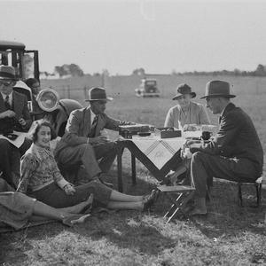 Group of spectators enjoy a picnic lunch