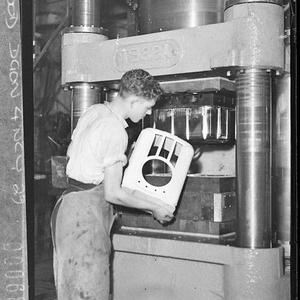 Factory worker takes moulded bakelite radio case from N...