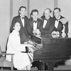Entertainers around a piano
