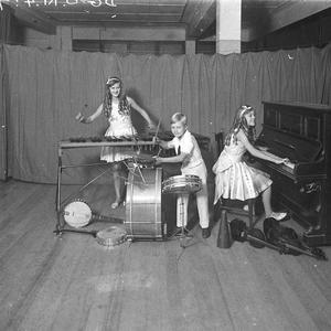 Three children musicians and their jazz band; piano, xy...