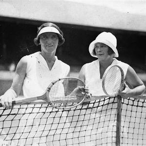 Miss R. Wilson and opponent at the net wearing hats