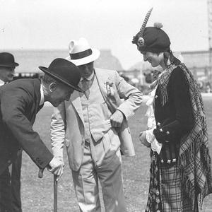 Sir Philip Game looking at the motif on a Highland lass...