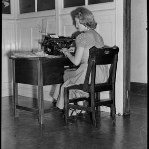 "Woman" office girl at desk. Lois Lurner, 15 March 1949 / photographs by Milton Kent