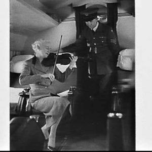 Royal Air Force officer and woman violinist in the pass...
