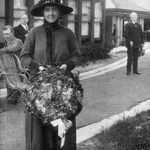 Unidentified woman with wreath, possibly Anzac Day. Dis...