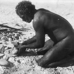 Aboriginal man grinding - Port Macquarie area, NSW