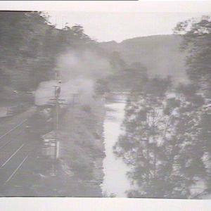 (MM) Steam train on line with water on either side