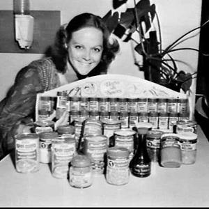 Woman with range of Masterfoods herbs and spices and bo...