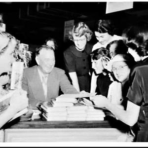 Author Edward V. Timms signs copies of his books, David...