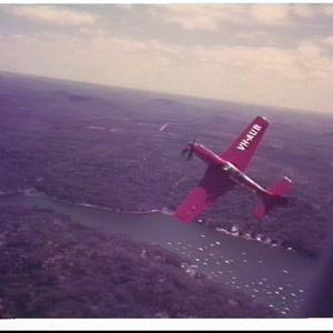 Aerial photograph of Aubrey Oates flying his red Mustan...