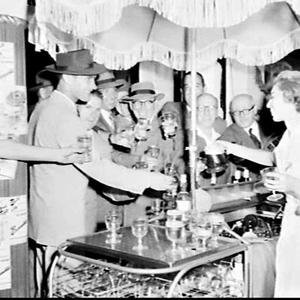 Barmaid serves drinks from a Mobilbars "Barmobile" at a...