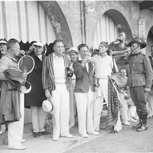 Tennis players drink a toast as Army bugler plays at A....