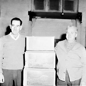Two storemen and packers with cartons of Stonyfell wine...