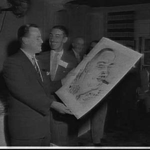 Tony Rafty presents a caricature of D. Manuel to the su...