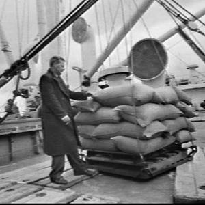 Loading sacks of rice onto the cargo ship Doros, Melbou...