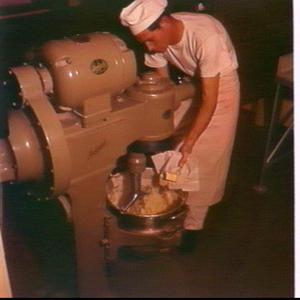 Sailor using Hobart industrial food mixer in the kitche...