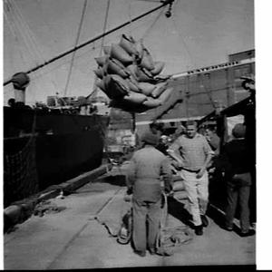 Loading rice in sacks onto the cargo ship Josephine, Py...