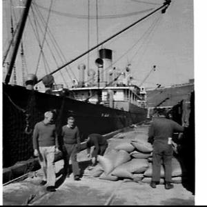 Loading rice in sacks onto the cargo ship Josephine, Py...