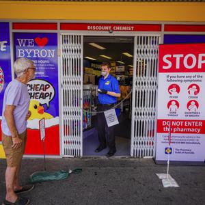 Item 13: An employee at Chemist Warehouse prepares to c...